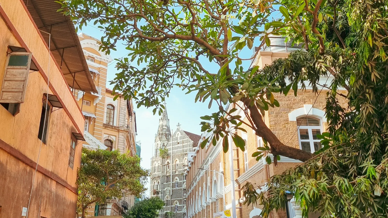A leafy Kala Ghoda lane in Colaba, heritage facades and a parked car